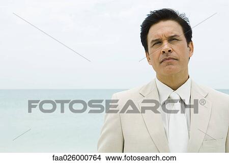 Picture - Businessman, sea in background. Fotosearch