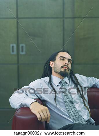 Businessman with dreadlocks leaning back, portrait View Large Photo Image Stock Photo - Businessman with dreadlocks leaning back, portrait. Fotosearch