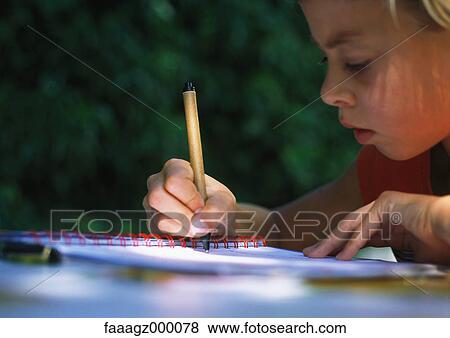 Stock Photo - Child doing homework. Fotosearch