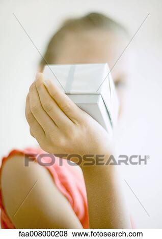 Child holding up gift View Large Photo Image Stock Photo - Child holding up gift. Fotosearch