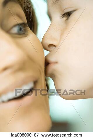 Child kissing woman's cheek View Large Photo Image Stock Photo - Child kissing woman's cheek. Fotosearch