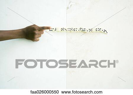 Child knocking over line of dominoes, cropped view of hand View Large Photo Image Stock Image - Child knocking over line of dominoes, cropped view of hand. Fotosearch