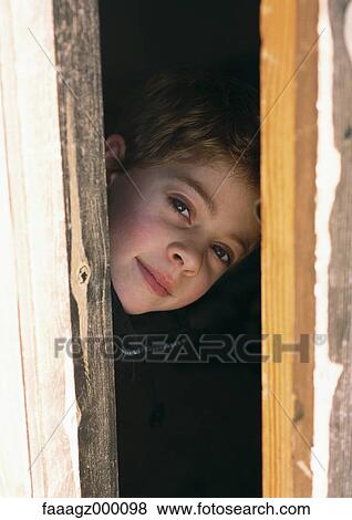 Child peeking through doorway View Large Photo Image Stock Photo - Child peeking through doorway. Fotosearch