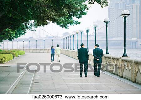 China, Guangzhou, pedestrians walking along waterfront, rear view View Large Photo Image Stock Image - China, Guangzhou, pedestrians walking along waterfront, rear view. Fotosearch