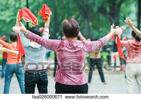 China, Guangzhou, women practicing tai chi chuan outdoors, rear view View Large Photo Image Stock Image - China, Guangzhou, women practicing tai chi chuan outdoors, rear view. Fotosearch