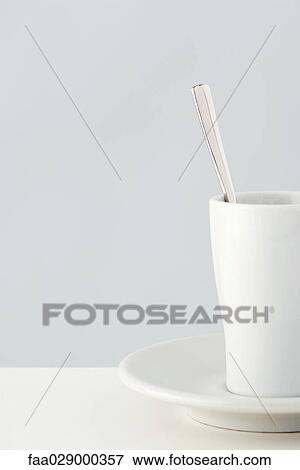 Stock Photo - Coffee cup and spoon, close-up, cropped. Fotosearch