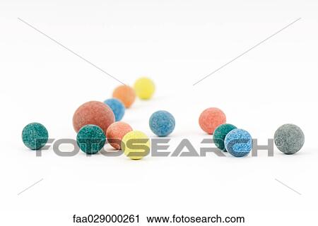 Stock Image - Colorful balls scattered over white surface. Fotosearch