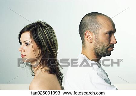 Couple back to back, both looking away, side view View Large Photo Image Stock Image - Couple back to back, both looking away, side view. Fotosearch