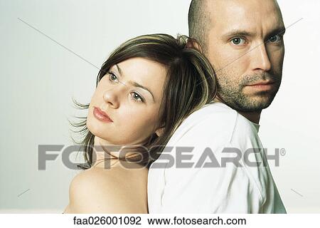 Couple back to back, woman's head on man's shoulder, man looking at camera View Large Photo Image Stock Image - Couple back to back, woman's head on man's shoulder, man looking at camera. Fotosearch