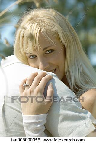 Couple embracing, woman smiling at camera View Large Photo Image Stock Photograph - Couple embracing, woman smiling at camera. Fotosearch
