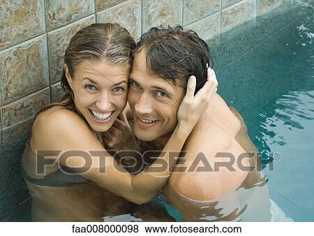 Couple in swimming pool, cheek to cheek, smiling at camera View Large Photo Image Stock Photo - Couple in swimming pool, cheek to cheek, smiling at camera. Fotosearch
