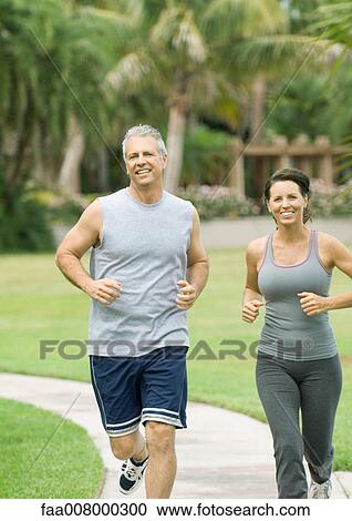 Couple jogging in park View Large Photo Image Stock Image - Couple jogging in park. Fotosearch