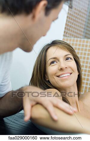Couple looking at each other, man touching woman's elbow, close-up View Large Photo Image Stock Image - Couple looking at each other, man touching woman's elbow, close-up. Fotosearch