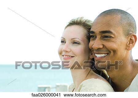 Couple looking away and smiling together, close-up View Large Photo Image Stock Image - Couple looking away and smiling together, close-up. Fotosearch