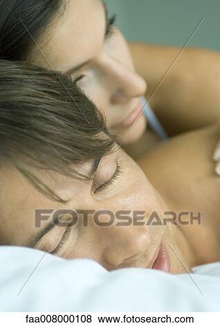 Stock Photo - Couple lying in bed together. Fotosearch