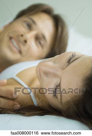 Couple lying in bed together View Large Photo Image Stock Photograph - Couple lying in bed together. Fotosearch