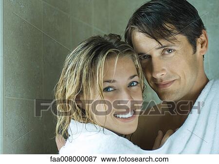 Couple sharing towel, looking at camera View Large Photo Image Stock Photo - Couple sharing towel, looking at camera. Fotosearch
