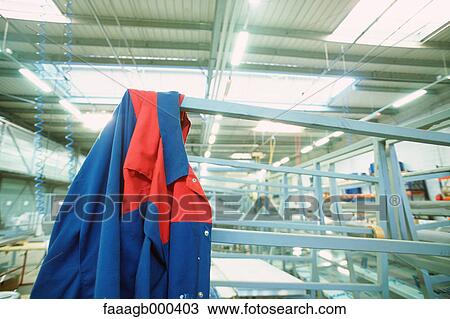 Stock Image - Coveralls in workshop. Fotosearch