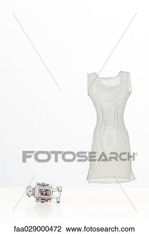 Stock Image - Fallen robot and floating dress. Fotosearch