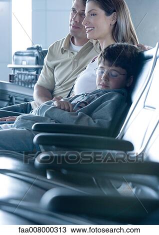 Family sitting in airport lounge, boy sleeping View Large Photo Image Stock Image - Family sitting in airport lounge, boy sleeping. Fotosearch
