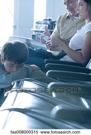 Family sitting in airport lounge, boy sleeping View Large Photo Image Stock Photography - Family sitting in airport lounge, boy sleeping. Fotosearch