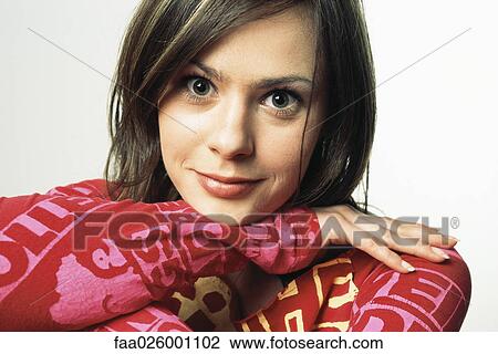Female with head resting on arms, smiling at camera, close-up View Large Photo Image Stock Image - Female with head resting on arms, smiling at camera, close-up. Fotosearch