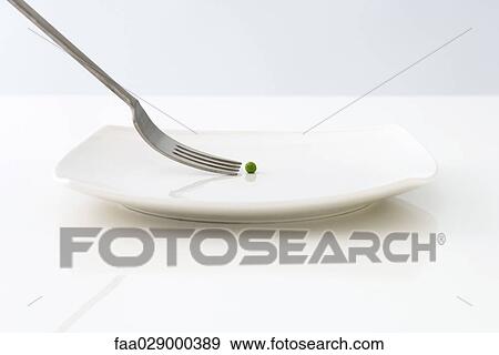 Stock Photo - Fork approaching single pea on plate. Fotosearch