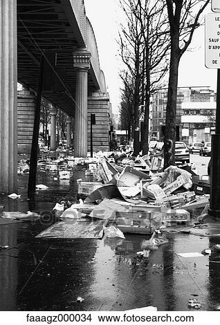 Picture - France, Paris, piles of trash next to street. Fotosearch