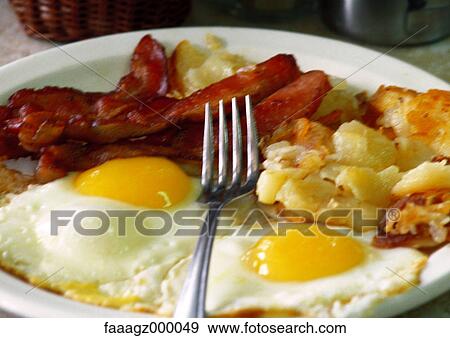 Fried eggs, bacon and hash browns View Large Photo Image Stock Photo - Fried eggs, bacon and hash browns. Fotosearch