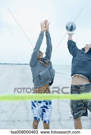 Friends playing beach volleyball View Large Photo Image Stock Image - Friends playing beach volleyball. Fotosearch