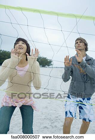 Friends playing beach volleyball View Large Photo Image Stock Photo - Friends playing beach volleyball. Fotosearch