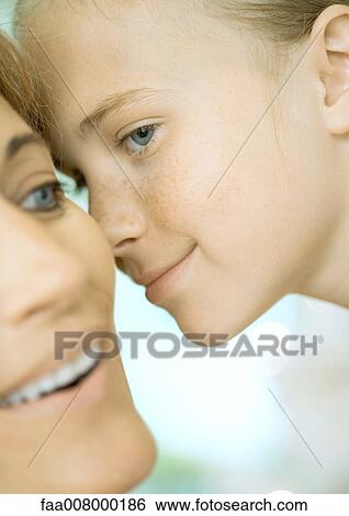 Girl about to kiss mother's cheek View Large Photo Image Stock Photograph - Girl about to kiss mother's cheek. Fotosearch