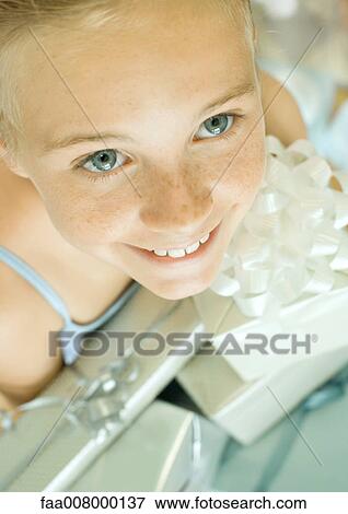 Girl holding armful of presents, high angle view View Large Photo Image Stock Photo - Girl holding armful of presents, high angle view. Fotosearch