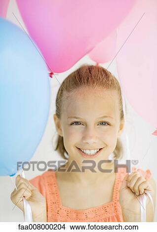 Girl holding balloons View Large Photo Image Picture - Girl holding balloons. Fotosearch