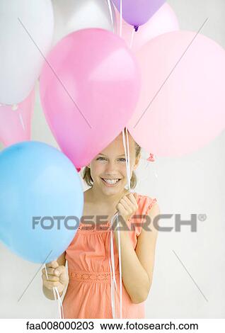 Girl holding balloons View Large Photo Image Stock Image - Girl holding balloons. Fotosearch