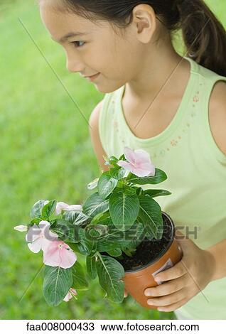 Girl holding potted plant View Large Photo Image Stock Image - Girl holding potted plant. Fotosearch