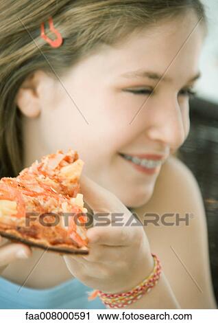 Girl holding slice of pizza View Large Photo Image Stock Image - Girl holding slice of pizza. Fotosearch