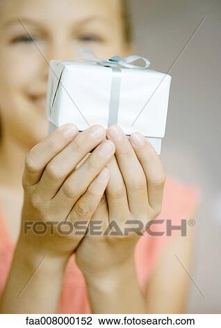 Girl holding up present View Large Photo Image Stock Image - Girl holding up present. Fotosearch