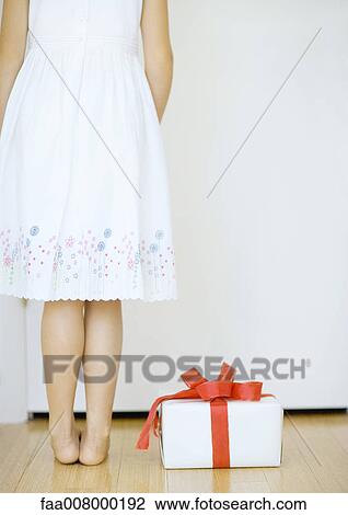 Girl standing next to gift View Large Photo Image Stock Image - Girl standing next to gift. Fotosearch