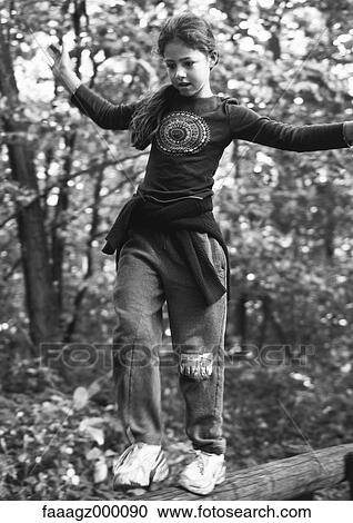Girl walking on log View Large Photo Image Stock Image - Girl walking on log. Fotosearch