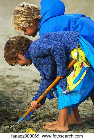 Girls digging in sand View Large Photo Image Stock Photography - Girls digging in sand. Fotosearch