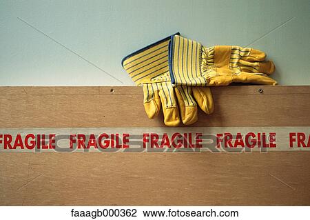 Stock Image - Gloves and "fragile" tape. Fotosearch