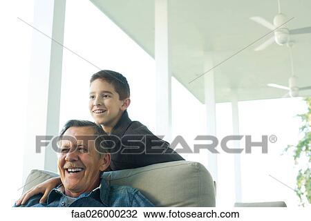 Grandfather and grandson together on porch, both smiling at looking away View Large Photo Image Stock Image - Grandfather and grandson together on porch, both smiling at looking away. Fotosearch