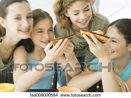 Group of preteen girls eating pizza View Large Photo Image Picture - Group of preteen girls eating pizza. Fotosearch
