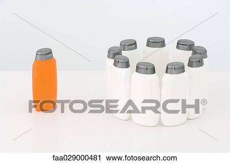 Group of white bottles in circle and single orange bottle View Large Photo Image Stock Image - Group of white bottles in circle and single orange bottle. Fotosearch
