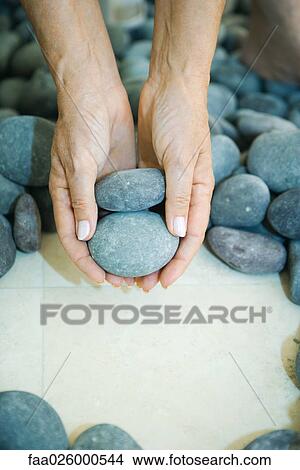 Hands holding pebbles, close-up View Large Photo Image Picture - Hands holding pebbles, close-up. Fotosearch