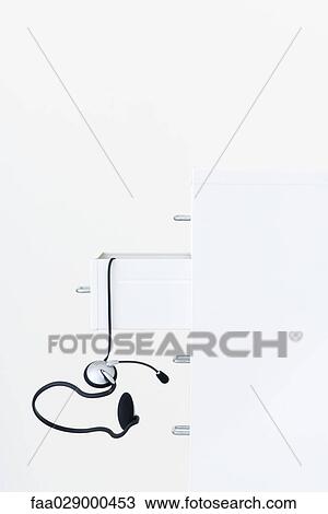 Headset falling out of filing cabinet View Large Photo Image Stock Image - Headset falling out of filing cabinet. Fotosearch