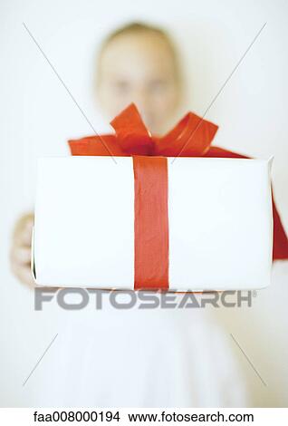 Picture - Holding out gift. Fotosearch