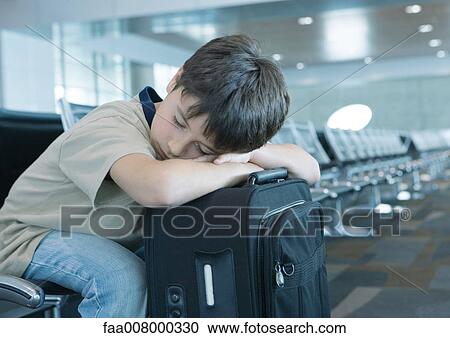 In airport lounge, boy resting head on suitcase, sleeping View Large Photo Image Stock Image - In airport lounge, boy resting head on suitcase, sleeping. Fotosearch