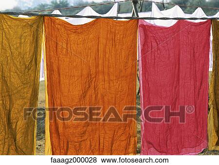 India, Uttar Pradesh, colored sheets hanging on clothes-line View Large Photo Image Stock Photo - India, Uttar Pradesh, colored sheets hanging on clothes-line. Fotosearch